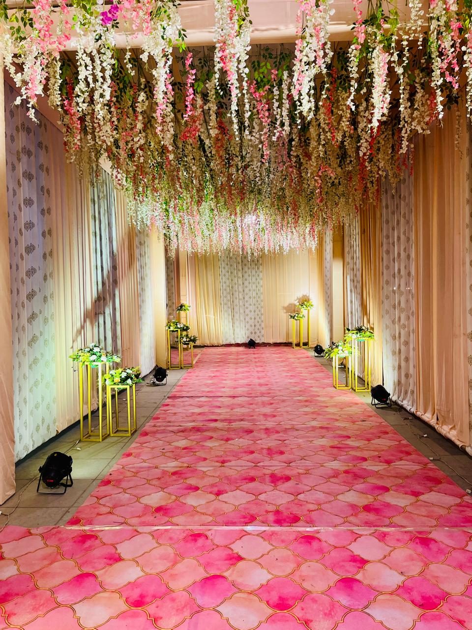 Floral canopy walkway with gold pedestal stands