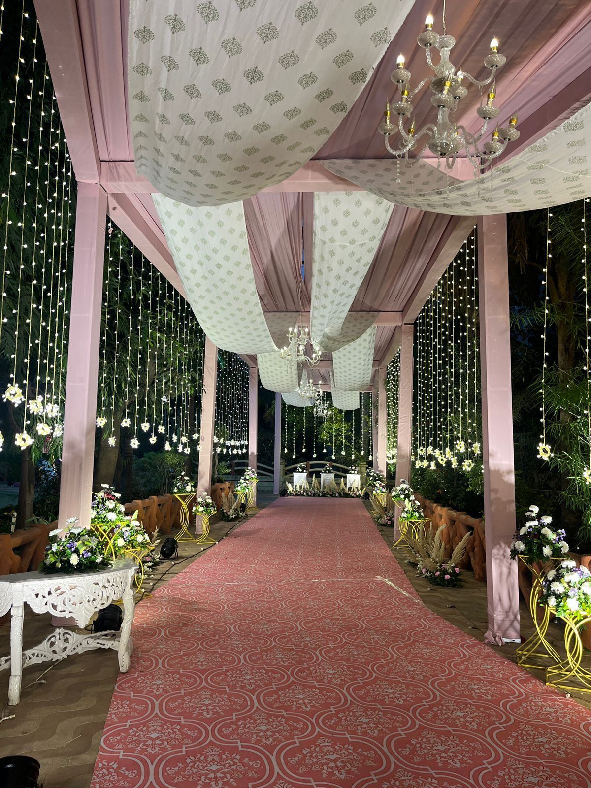 Night walkway with chandeliers and fairy lights