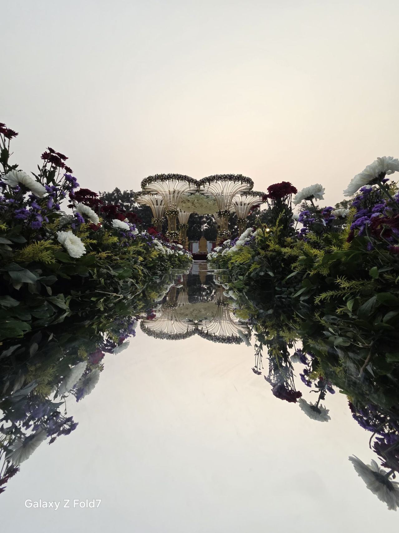 Mirror-finish wedding mandap decor reflecting floral arrangements